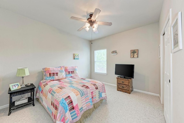 carpeted bedroom featuring baseboards and ceiling fan