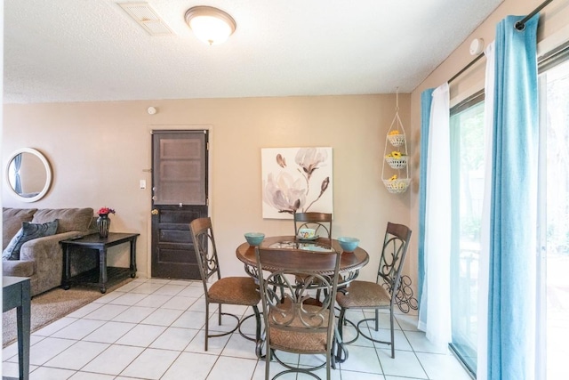 dining room featuring visible vents and light tile patterned floors