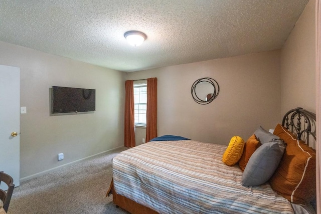 bedroom with baseboards, carpet, and a textured ceiling