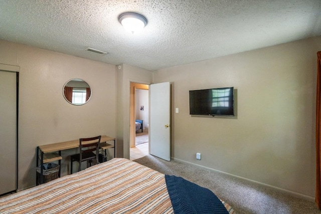 carpeted bedroom featuring visible vents, a textured ceiling, and baseboards