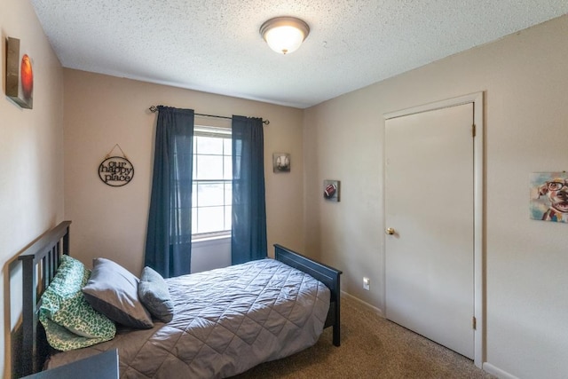 carpeted bedroom featuring a textured ceiling