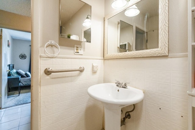 bathroom with a wainscoted wall and tile walls