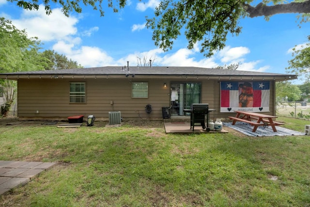 back of house with a lawn and a patio