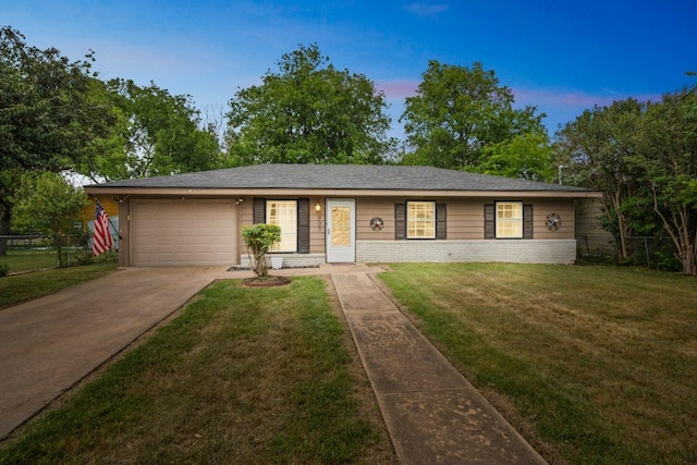 ranch-style house with fence, an attached garage, concrete driveway, and a front yard