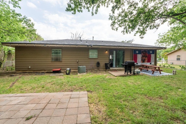 back of house with a patio, central air condition unit, fence, and a yard
