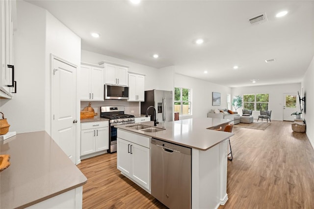 kitchen featuring visible vents, a sink, appliances with stainless steel finishes, and a wealth of natural light