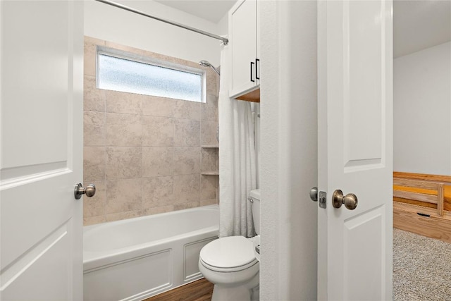 bathroom with shower / bath combo and toilet