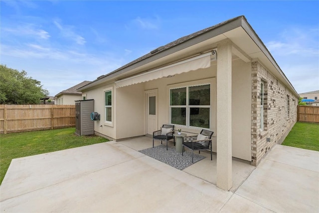 rear view of house with a yard, a patio, a fenced backyard, and stucco siding