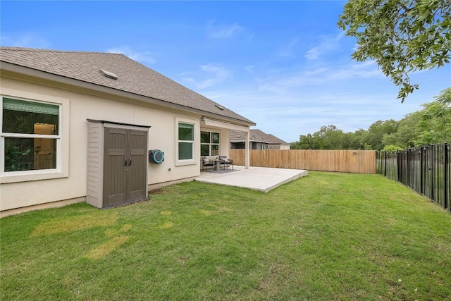 back of house featuring a shingled roof, stucco siding, a fenced backyard, a patio, and a yard