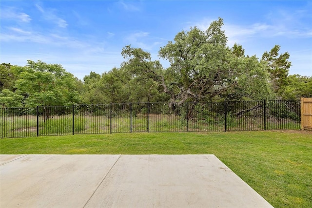 view of yard featuring fence and a patio