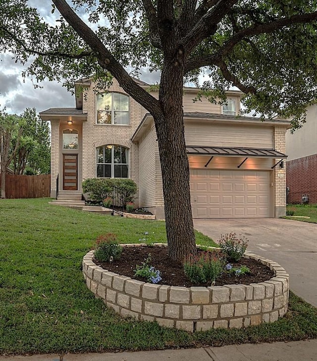 traditional-style home featuring a garage, a front lawn, fence, brick siding, and driveway