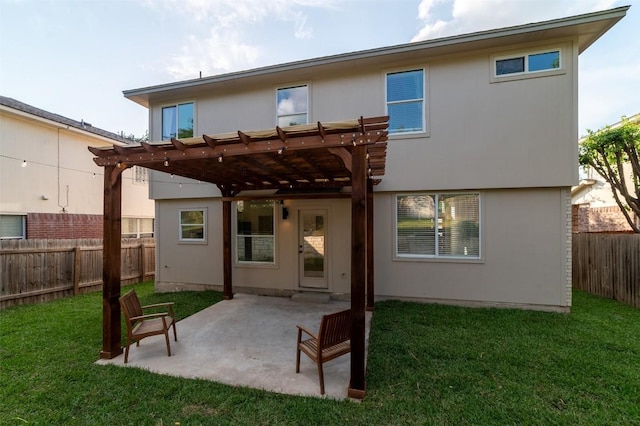 rear view of house with a lawn, a fenced backyard, a patio area, and a pergola