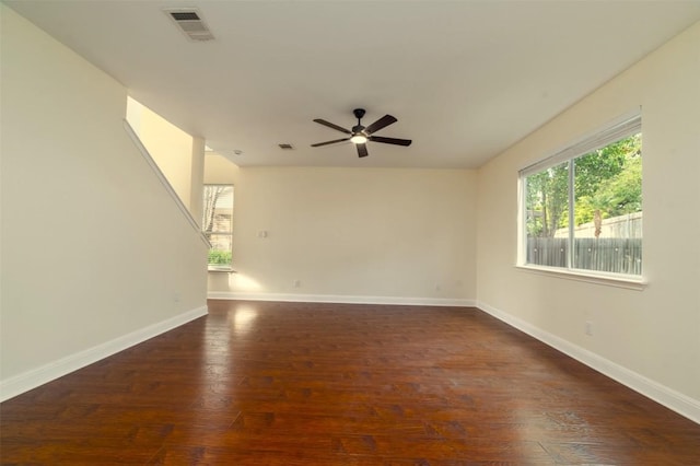 unfurnished room featuring baseboards, ceiling fan, wood finished floors, and visible vents