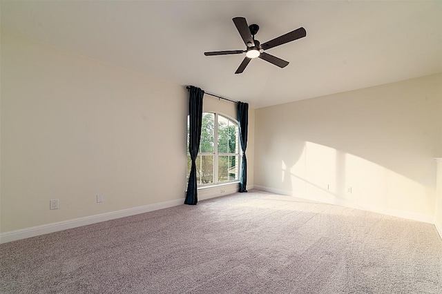 carpeted empty room with baseboards and ceiling fan