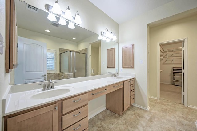 full bath featuring a sink, a shower stall, double vanity, and visible vents