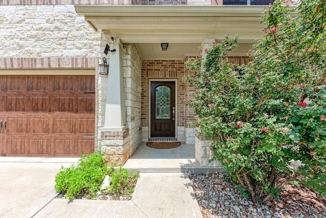 2119 Howell Mountain Dr, Cedar Park, TX 78613 - doorway to property with stone siding, an attached garage, and brick siding