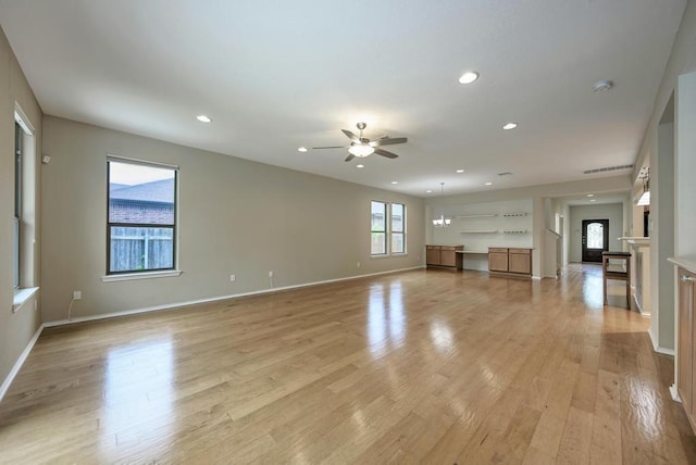 unfurnished living room featuring a ceiling fan, a fireplace, baseboards, light wood-style floors, and recessed lighting