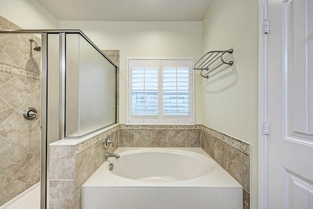 full bath with a bath and a shower stall