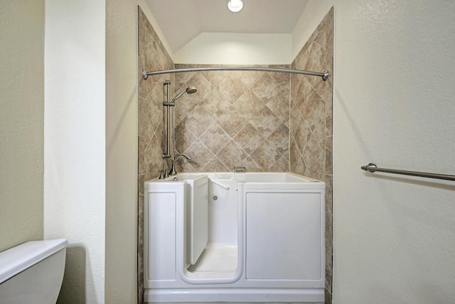 full bathroom featuring walk in shower and toilet