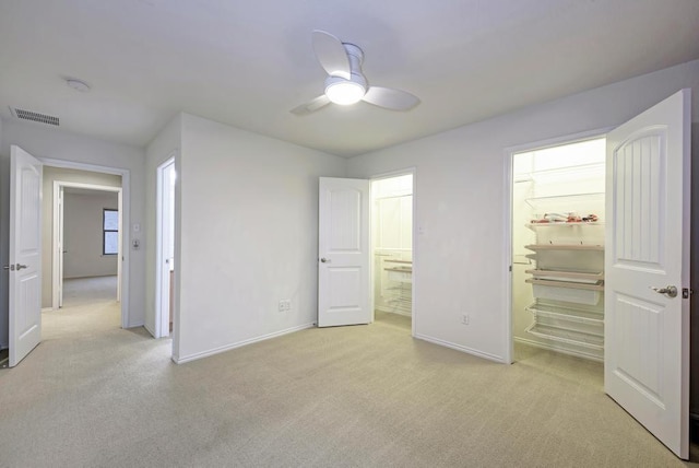 unfurnished bedroom with baseboards, visible vents, and light colored carpet