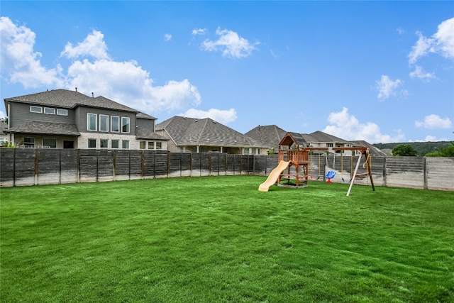 view of yard featuring a playground and a fenced backyard