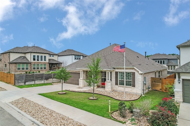 view of front of property featuring concrete driveway, fence, a front lawn, and a garage