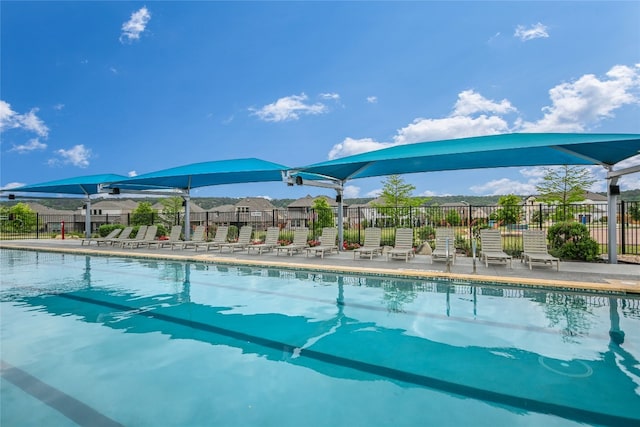 community pool featuring fence and a patio area