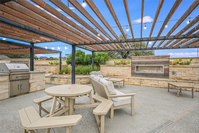 view of patio / terrace featuring an outdoor stone fireplace, a pergola, and area for grilling