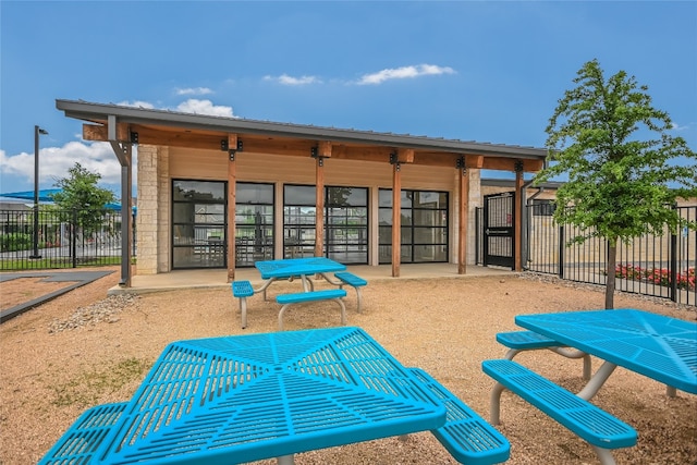 view of home's community with fence and a patio