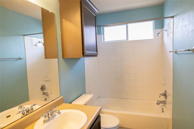 bathroom featuring toilet, shower / washtub combination, and vanity