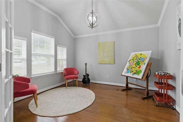 living area with crown molding, baseboards, wood finished floors, and vaulted ceiling