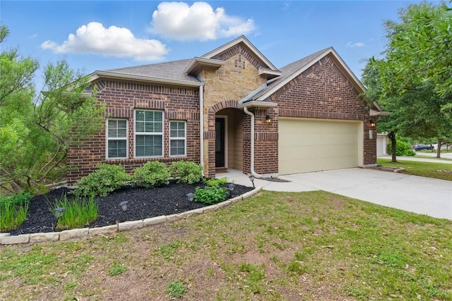 view of front of house with driveway, brick siding, a front lawn, an attached garage, and stone siding