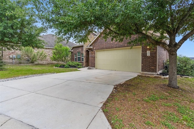 view of front of home featuring concrete driveway, brick siding, an attached garage, and a front yard