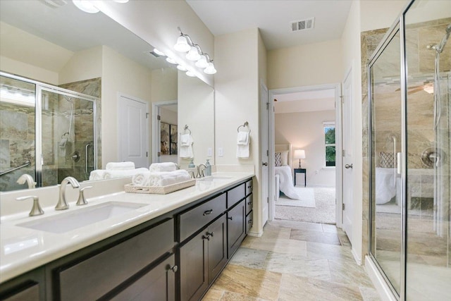 ensuite bathroom featuring visible vents, a shower stall, a sink, and ensuite bath