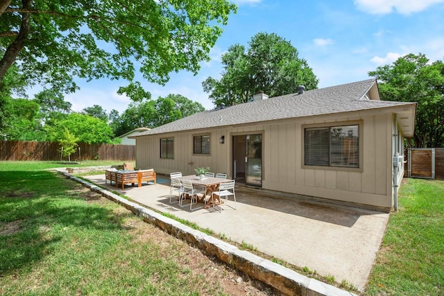 rear view of property featuring fence, a patio, roof with shingles, a chimney, and a lawn