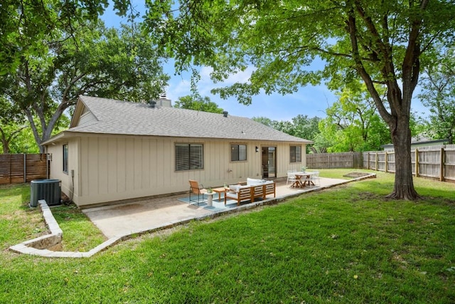 rear view of house featuring a lawn, a shingled roof, a fenced backyard, and a patio area