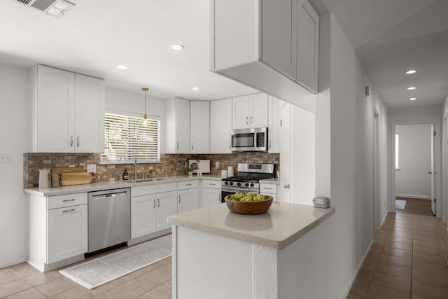 kitchen with visible vents, tasteful backsplash, a sink, light tile patterned floors, and stainless steel appliances