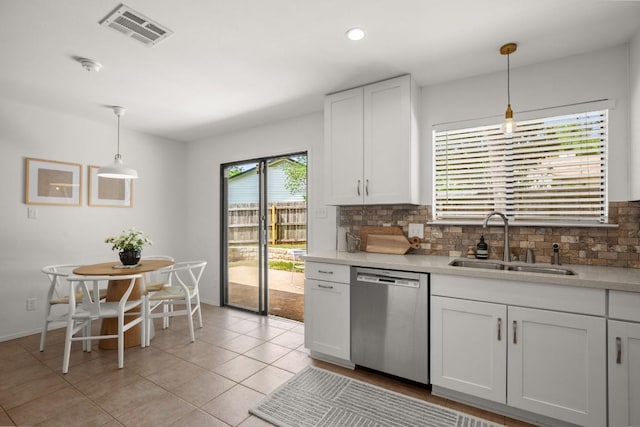 kitchen with visible vents, dishwasher, white cabinets, a sink, and backsplash