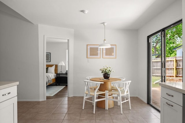 dining room featuring baseboards and light tile patterned floors