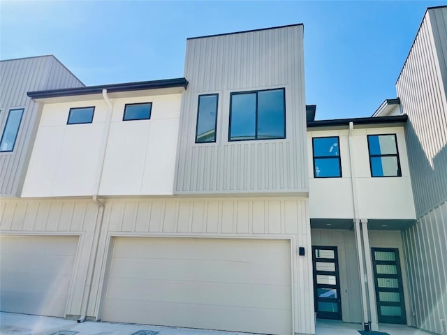multi unit property with a garage and board and batten siding