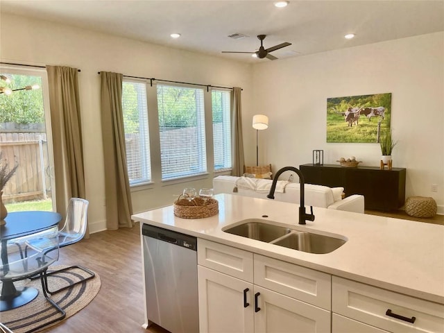 1811 Webberville Rd Unit 2101, Austin, TX 78721 - kitchen with dishwasher, a sink, light wood finished floors, light countertops, and ceiling fan
