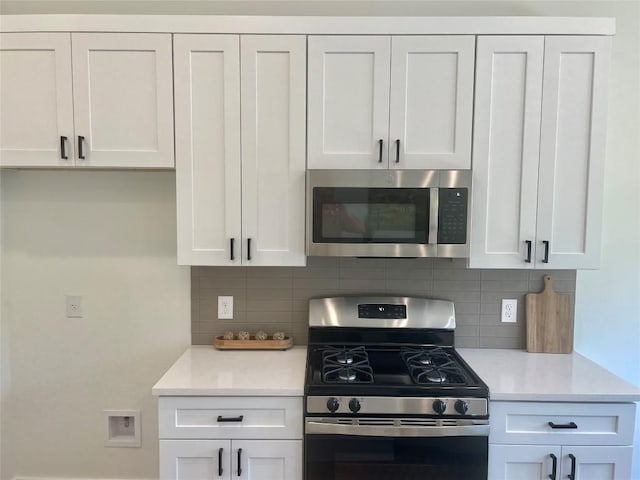kitchen featuring white cabinetry, appliances with stainless steel finishes, and tasteful backsplash