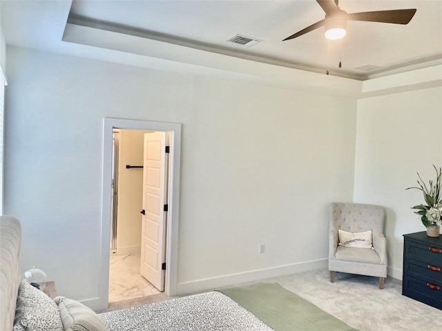 bedroom with connected bathroom, ceiling fan, a raised ceiling, baseboards, and visible vents