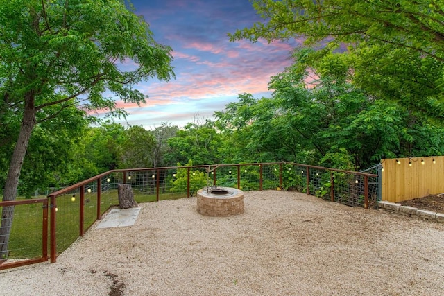 view of patio / terrace with a fire pit and fence
