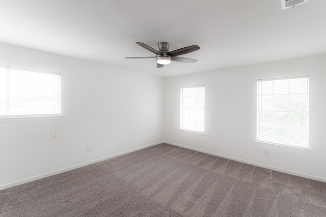 unfurnished room featuring visible vents, baseboards, ceiling fan, and light carpet