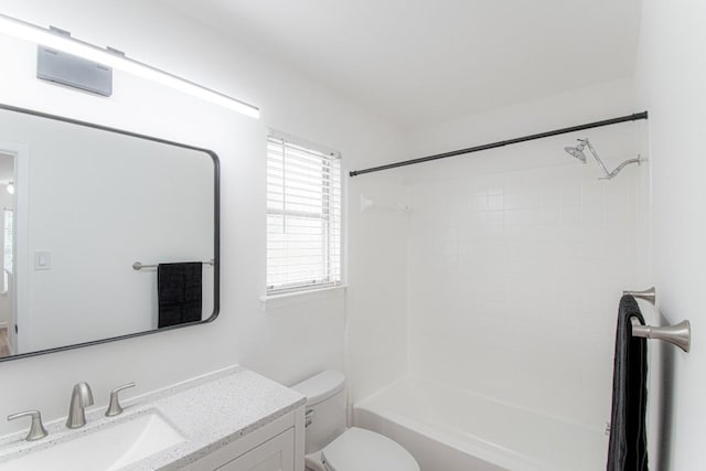 bathroom featuring toilet,  shower combination, and vanity