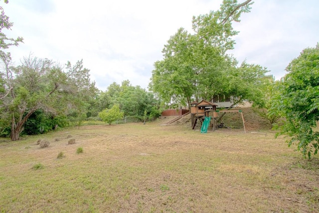 view of yard featuring a playground and fence