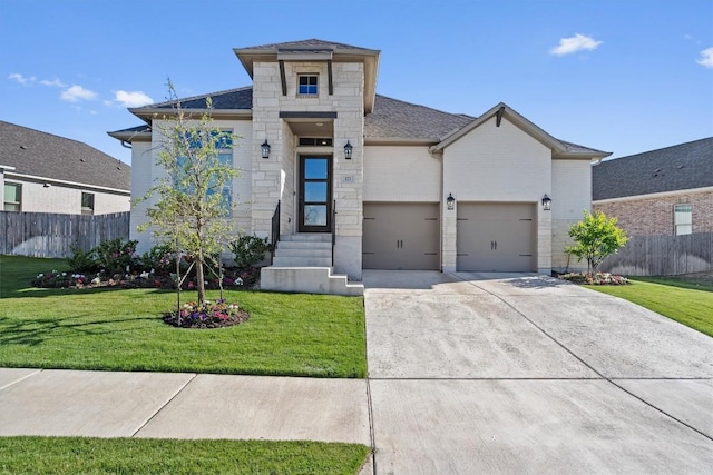 view of front of home with a garage, fence, a front yard, a shingled roof, and concrete driveway