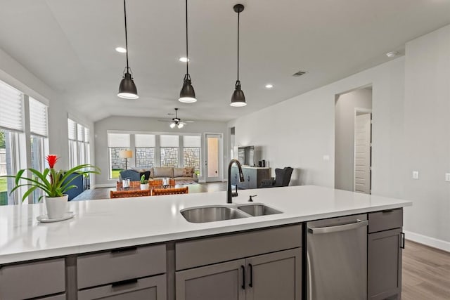 171 William Clayton Dr, Buda, TX 78610 - kitchen featuring dishwasher, open floor plan, gray cabinetry, light wood-style floors, and light countertops