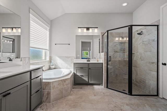 171 William Clayton Dr, Buda, TX 78610 - bathroom featuring a shower stall, a garden tub, two vanities, and lofted ceiling